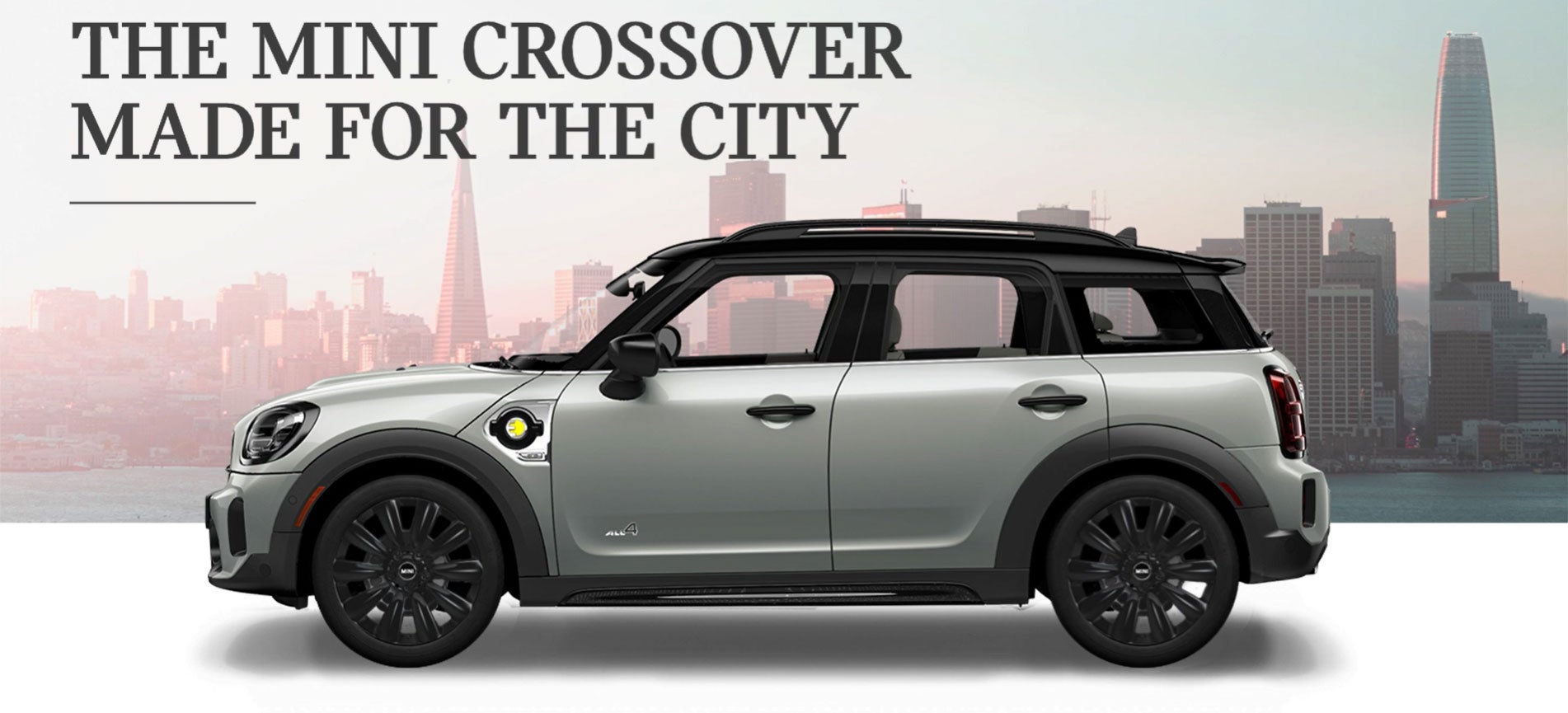 The MINI Cooper SE Countryman PHEV parked in front of a city scape. MINIDemo3 in Derwood MD