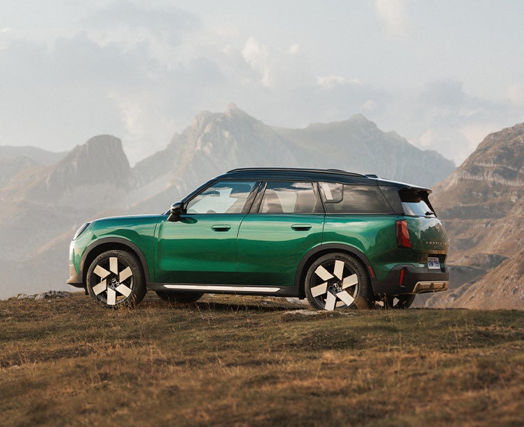 Side profile shot of British racing green MINI Countryman. 